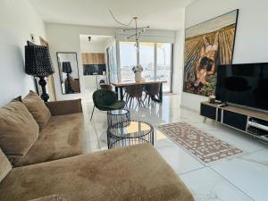 a living room with a couch and a television at City Lights - Luxury Penthouse - Panoramic view - Near Unic in Nicosia