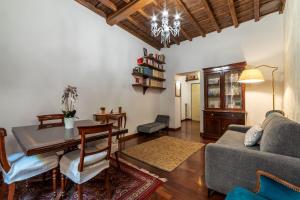 a living room with a table and a couch at Trevi Garden Suite in Rome