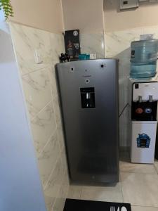 a small refrigerator in a room with marble walls at Olivia homes in Nairobi