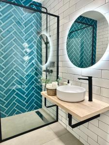 a bathroom with a sink and a mirror at El Submarino Coastal Home in Santa Maria de Guia de Gran Canaria +32 photos