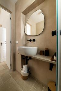 a bathroom with a white sink and a mirror at DIMORA Santa Lucia - LUXURY HOUSE in Monopoli +83 photos