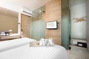 Rúm í herbergi á Whiz Prime Hotel Kelapa Gading