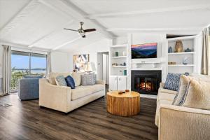 a living room with two couches and a fireplace at Lakefront Mountain Oasis in Dandridge