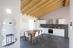 a kitchen and dining room with a wooden table and chairs at Casa BEA 4 in Castione della Presolana