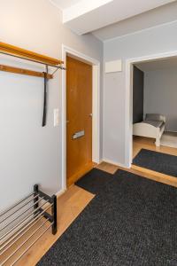 a room with a door and a bedroom with a bed at Spacious one-bedroom apartment near downtown in Lahti