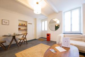 a living room with a table and a mirror at Bocadasse Beach| Wifi| Boho Luxury By Tilo in Genova