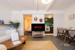 a living room with a couch and a table at Bocadasse Beach| Wifi| Boho Luxury By Tilo in Genova