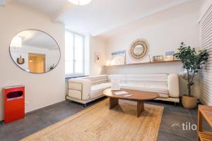 a living room with a couch and a table at Bocadasse Beach| Wifi| Boho Luxury By Tilo in Genova +14 photos