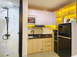 a small kitchen with a sink and a refrigerator at Quattrick Villa in Tlekung