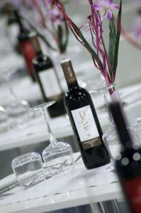 a bottle of wine and glasses on a table at Aurea Hotel in Tortoreto Lido