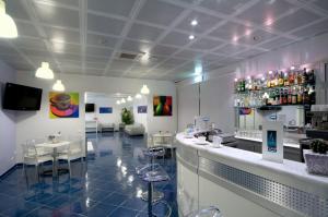 a restaurant with a bar and some tables and chairs at Aurea Hotel in Tortoreto Lido