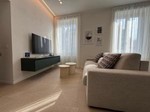 a living room with a couch and a flat screen tv at Il Torretto in La Spezia