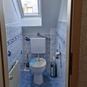 a small bathroom with a toilet with a window at Ferienwohnung Sonnenschein in Weinheim +18 photos