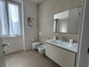 a white bathroom with a toilet and a sink at Il Torretto in La Spezia +17 photos