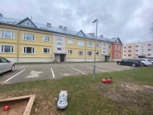a parking lot in front of a large building at Apartment with a jacuzzi close to Tehvandi in Otepää