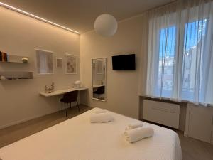 a bedroom with a bed and a desk and a window at Il Torretto in La Spezia