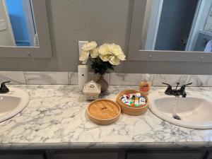 a bathroom counter with two sinks and a bowl of toothpaste at SLCa in Austin
