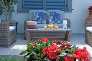 a patio with a table with two glasses of orange juice at Ocean escape with private pool in Arco da Calheta