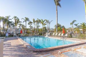 a swimming pool at a resort with palm trees at Captiva Beach Resort (open private beach access) in Sarasota