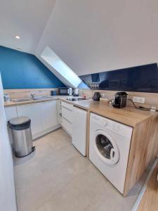 a laundry room with a washer and dryer in it at Le Petit Langlet - Cathedral - hyper-center in Reims +6 photos