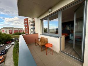 a balcony with a table and a chair on a building at Cozy Spot Olomouc in Olomouc