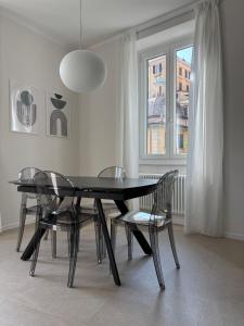 a dining room with a black table and chairs at Il Torretto in La Spezia