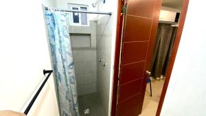 a shower with a glass door in a bathroom at Hostal TO3 in Ciudad Madero