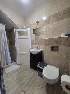 a bathroom with a toilet and a sink and a shower at Siodemkacamp Karwia in Karwia +51 photos