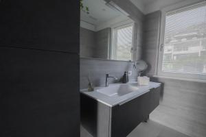 a bathroom with a sink and a mirror at Attico Sky Lake Holiday Luxury Apartament in Riva del Garda +19 photos