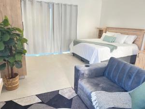 a living room with a bed and a couch at Deluxe Dwellings 3 in East London