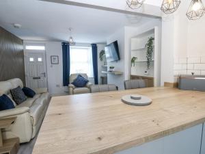 a kitchen and living room with a large wooden table at Keekle Terrace in Cleator Moor