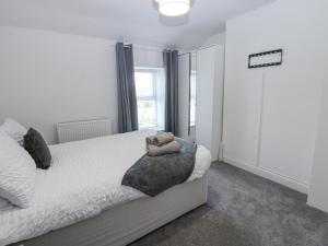 a bedroom with a bed and a large window at Keekle Terrace in Cleator Moor