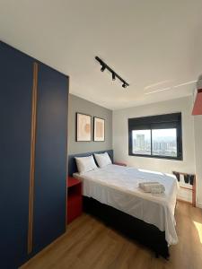 ein Schlafzimmer mit einem großen Bett und einem Fenster in der Unterkunft TrevizZo Allianz Parque Palmeiras in São Paulo + 16 Fotos