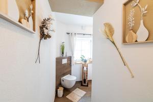 a bathroom with a toilet in a hallway at Ferienbahnhof Fichtental Bahnhofs-Lodge in Prackenbach +12 photos