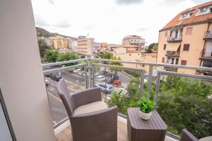 a balcony with chairs and a view of a city at Tropea Alto Borgo Rooms in Tropea