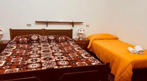 Łóżko lub łóżka w pokoju w obiekcie Albergo Belvedere
