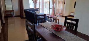 a living room with a table and chairs and a dining room at Zamia Heights Apartments in Gatunga +18 photos