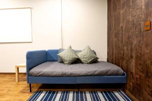 a blue couch with pillows on it in a room at 504 Cozy AC apt Zocalo Rooftop in Mexico City +42 photos