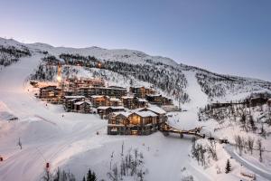 a resort in the middle of a snow covered mountain at Skigaarden in Hemsedal