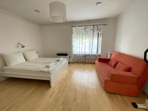 a living room with a bed and a couch at Első Ház Tagyon in Tagyon