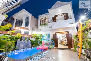 a house with a water park in front of it at Villages Hồ Bơi free Xe Máy HM Gần Quảng Trường Bãi Sau in Vung Tau