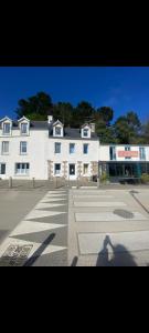 a shadow of a person standing in front of a building at Duplex plage de brehec in Plouézec
