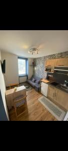 a living room with a couch and a table at Duplex plage de brehec in Plouézec