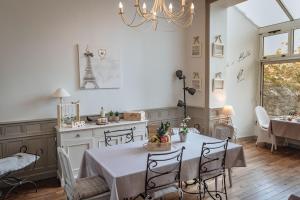 a kitchen and dining room with a table and chairs at La Villa Côté Cour in Dinan +13 photos