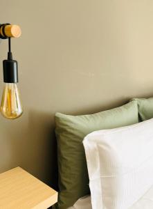 - une chambre avec un lit doté d'une lampe et d'un oreiller dans l'établissement cozy isola garden, à Milan