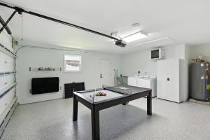 a room with a table in the middle of a room at Sunny 3BR with Hot Tub & Game Room Home in Gulf Breeze