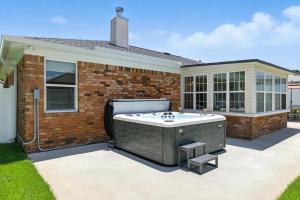 a hot tub in the backyard of a house at Sunny 3BR with Hot Tub & Game Room Home in Gulf Breeze