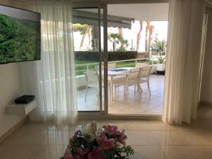 a dining room with a table and chairs on a patio at T2 & Garage FRONT DE MER résidence de Standing in Fréjus