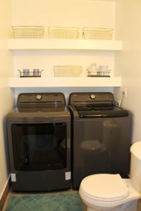 a kitchen with a black stove and a toilet at Townhome - El Fuerte in Riverdale +68 photos