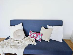 a blue couch with a bunch of pillows on it at Citadella View Point apartment with Huge Balcony for 6 ppl, free Parking, AC in Budapest +36 photos
